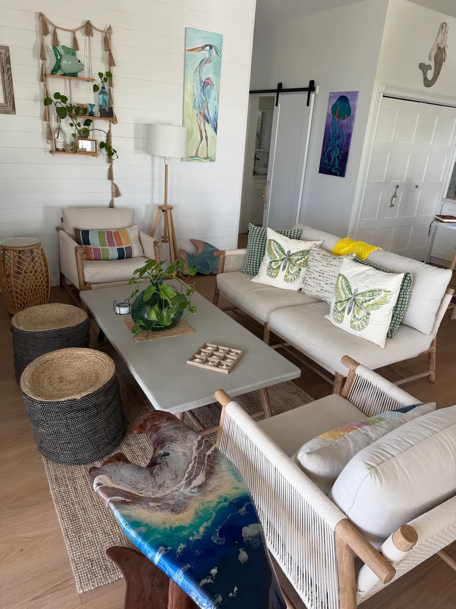 Cozy lounge corner with island artwork and handmade details at Blue Moon Cottage