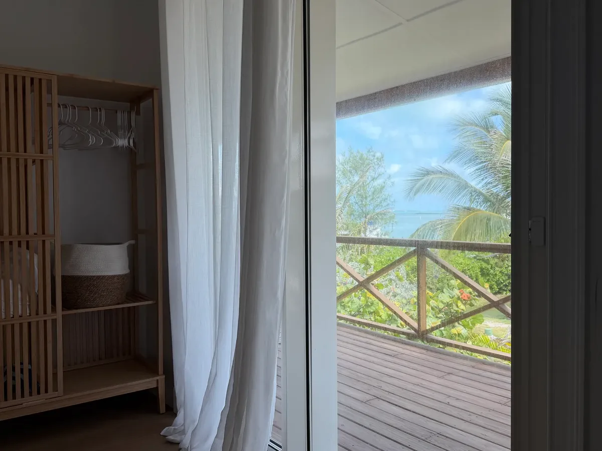 Veranda and sea views from the bedroom at Blue Moon Cottage