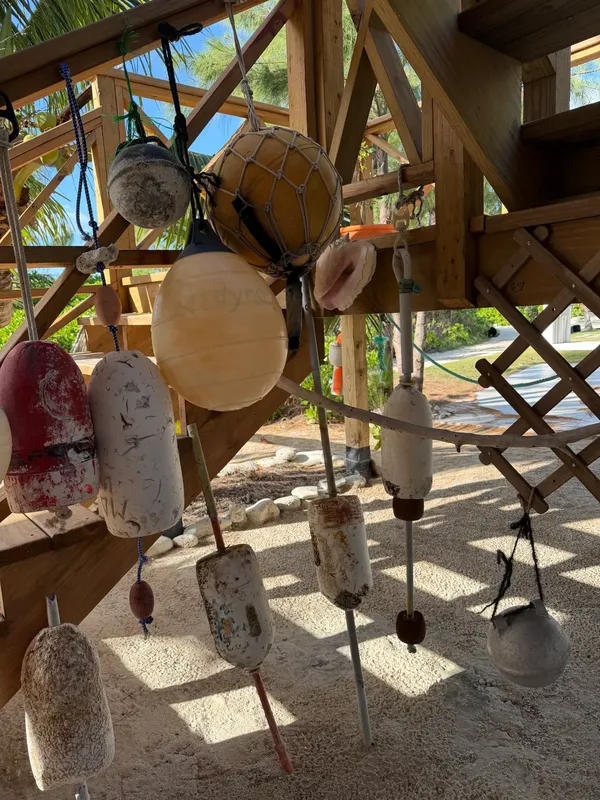 Collected buoys hanging by the stairs at Blue Moon Cottage
