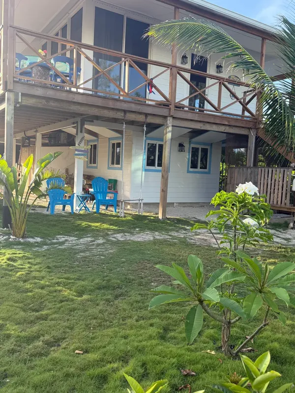 Blue Moon Cottage seen from the garden, with its wraparound veranda